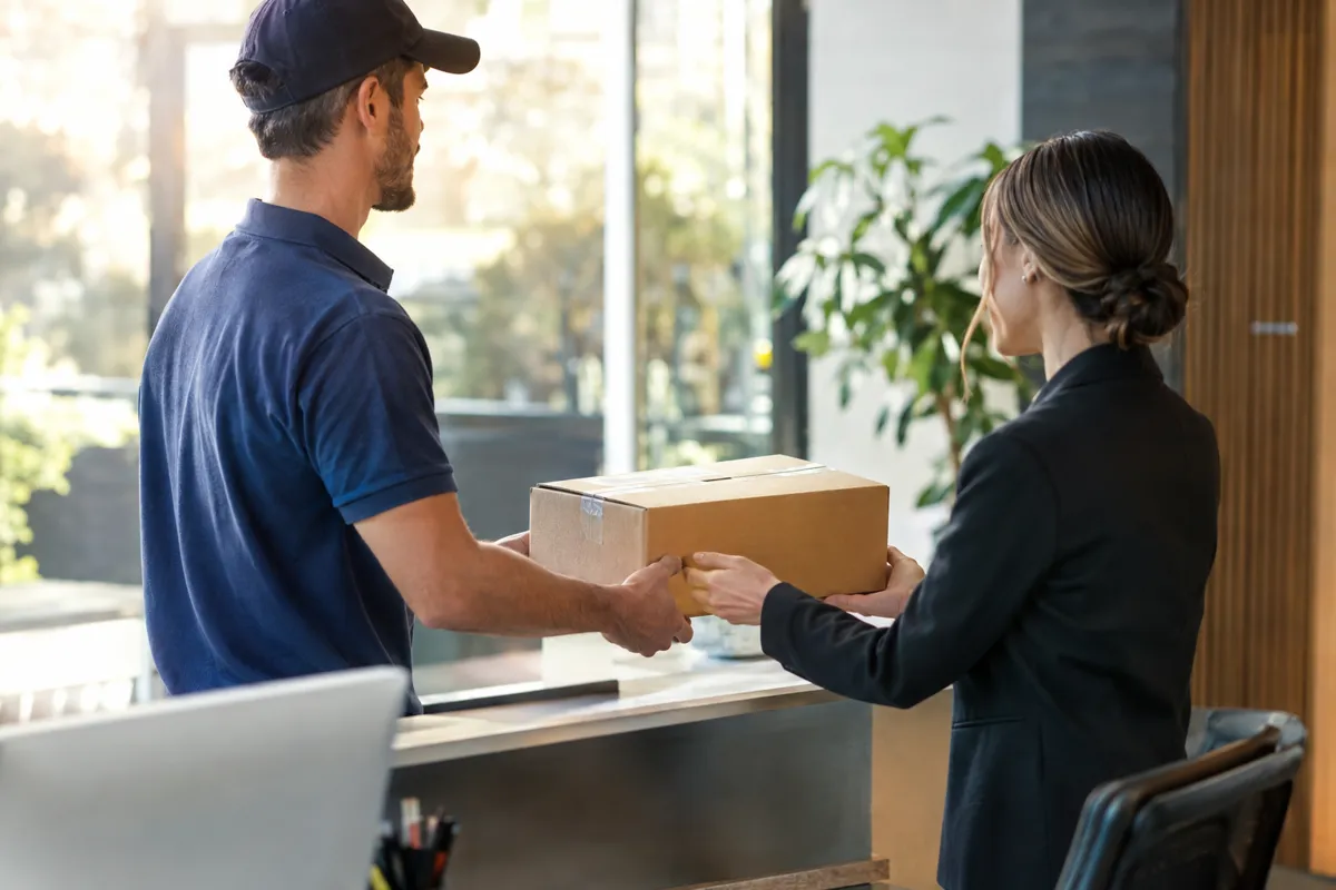 Driver hand-delivering a package at an office